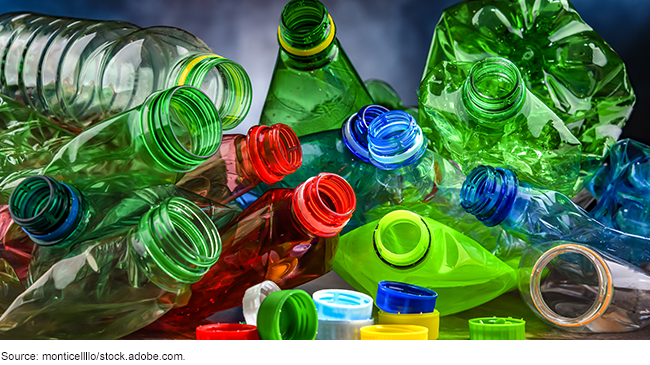 different colored empty plastic bottles and bottle caps. 