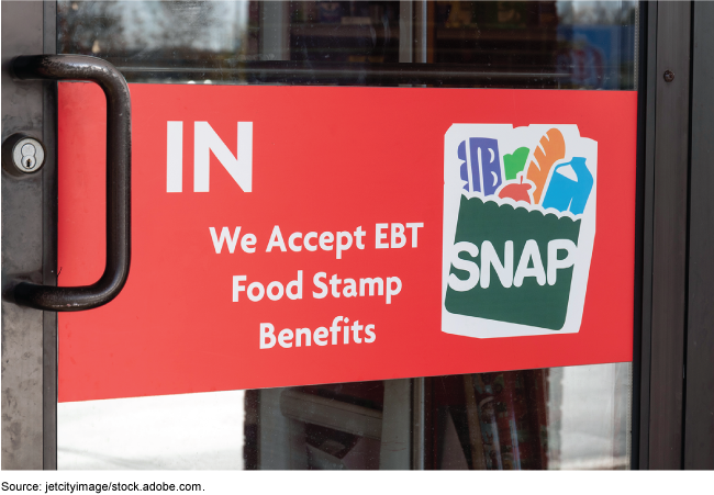 A door with a SNAP sign indicating it accepts EBT food stamp benefits.