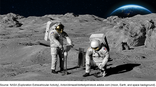 Two astronauts in space suits working with tools on the moon.