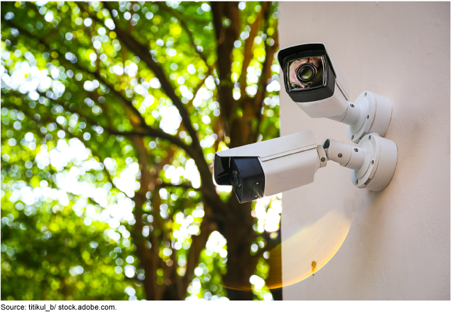 Two security cameras mounted on an exterior structure