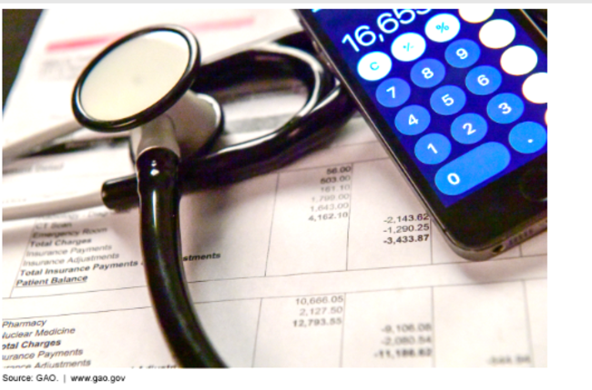 Photo of stethoscope, calculator, and medical bill.