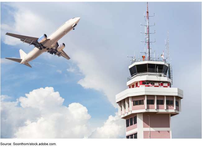 Plane flying over an air traffic control tower