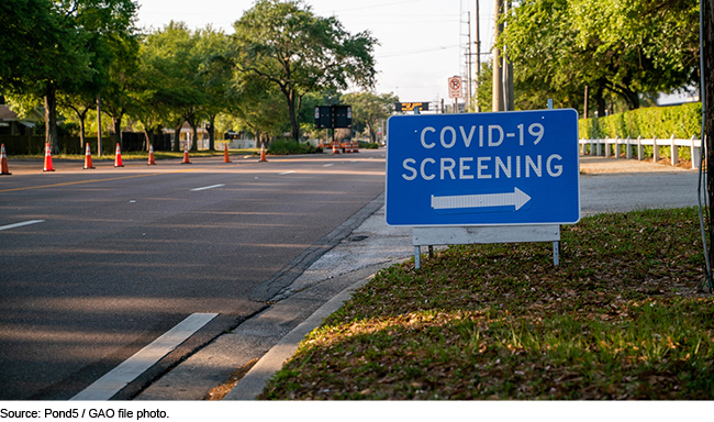 Signing pointing toward COVID-19 screening