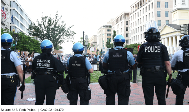Federal police officers in helmets lined up at a Washington, D.C. plaza