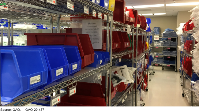 Blue and red file bins on metal shelves.