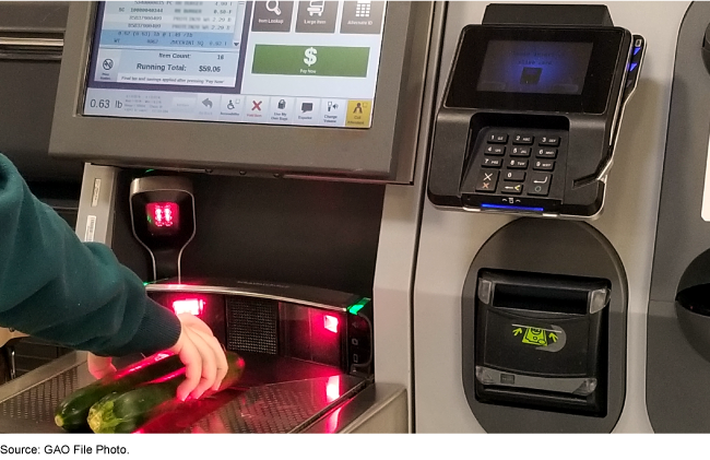 A person places vegetables on a self-check-out machine.