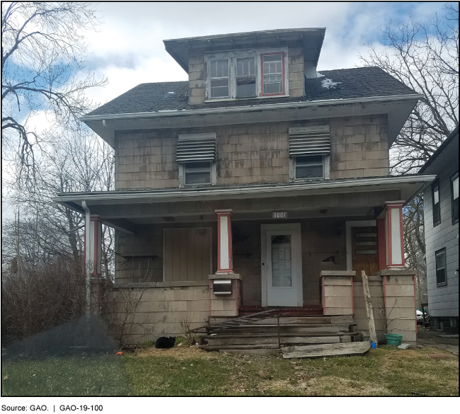Picture of a house with broken windows and steps.