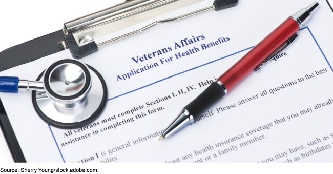 Veterans Affairs application for health benefits on a clipboard