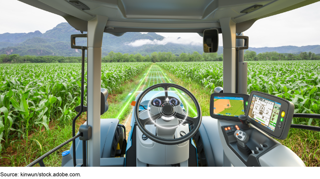 An artist rendition of an autonomous tractor working in a corn field.