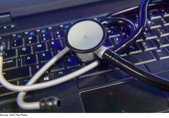 A stethoscope laying on a laptop keyboard. 