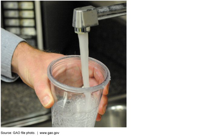 A person filling a cup with tap water