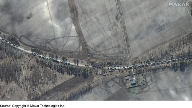 A satellite picture that shows a military convoy moving in a singular line on a road.