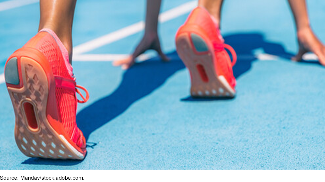 A person in running shoes lining up for a race