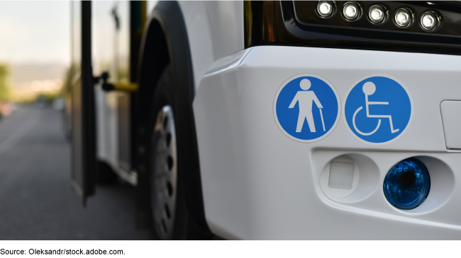 2 blue stickers on a vehicle, one depicting a person who uses a wheelchair and one of a person who uses a cane.