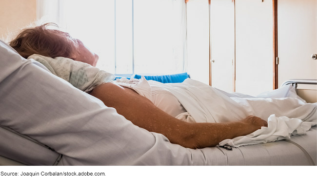 An elderly patient in a hospital bed