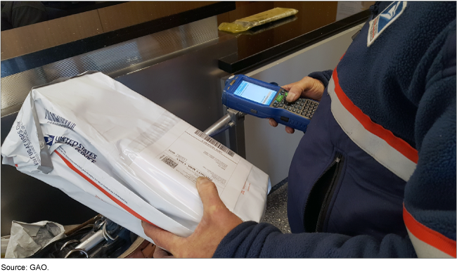 A postal worker scanning a USPS package with a handheld device