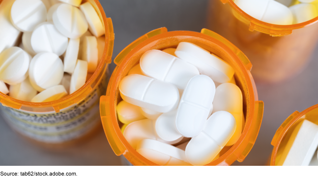 Overhead view of prescription drugs in open pill bottles