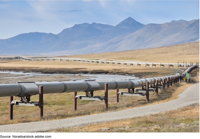 a pipeline with mountains in the background