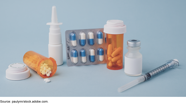 Pills, a needle, and nose spray all together to show many different ways to take medication.