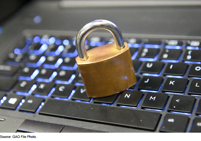 A padlock resting on a computer keyboard.