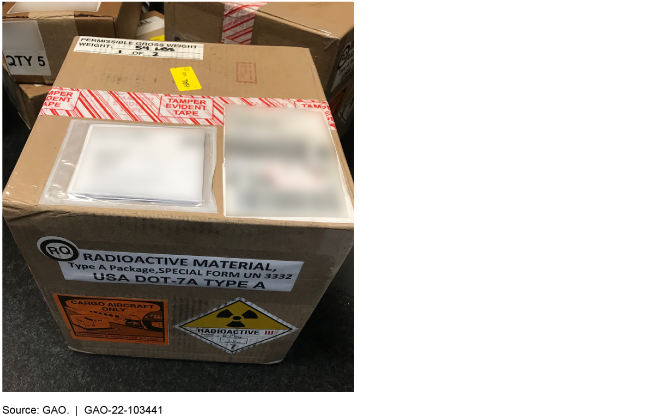 a cardboard box with labels indicating it contains radioactive material