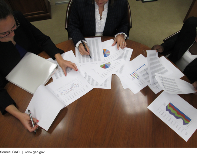 Photo of business women reviewing paperwork.