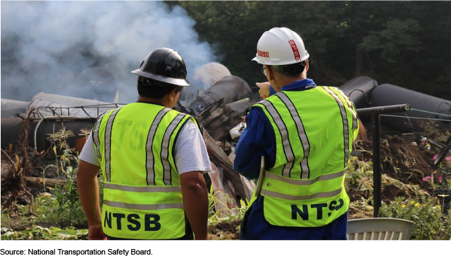 An image of two transportation safety employees assessing a crash site.