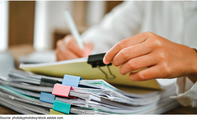 A person reviewing reports or court papers.