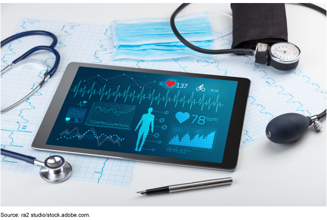 a stethoscope, blood pressure monitor, and tablet showing health data 