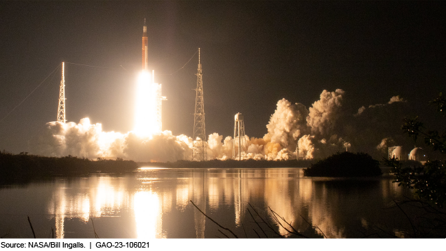 Plumes of smoke billowing out as Artemis 1 launches from across a lake. 