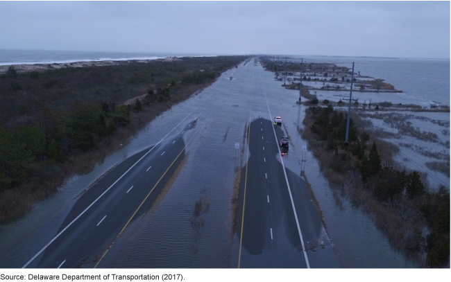 A flooded road between two bodies of water