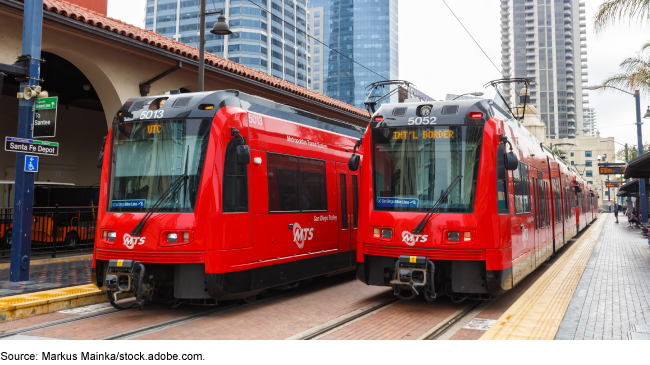 Two red commuter trains sitting side by side at the Santa Fe Depot in San Diego, California