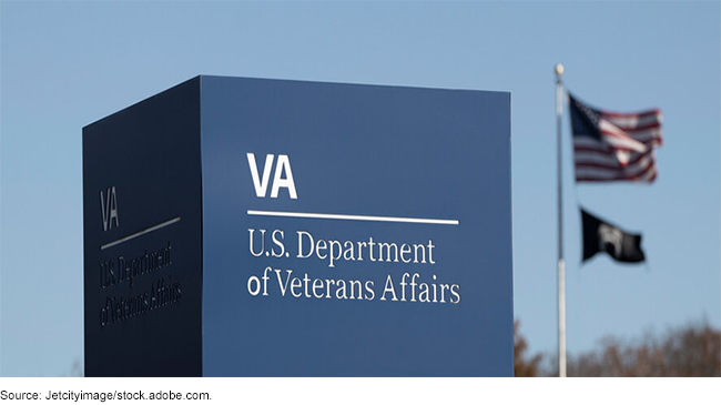 The Department of Veterans Affairs' sign with a U.S. and POW/MIA flags in the background.
