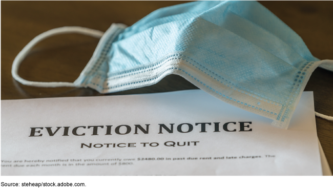 A blue surgical mask on top of an eviction notice.