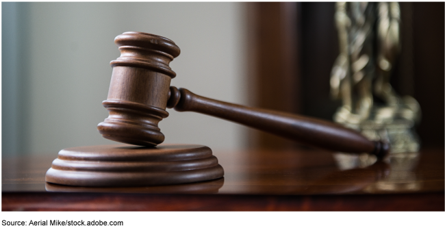 An image of a judge's gavel on a desk. 