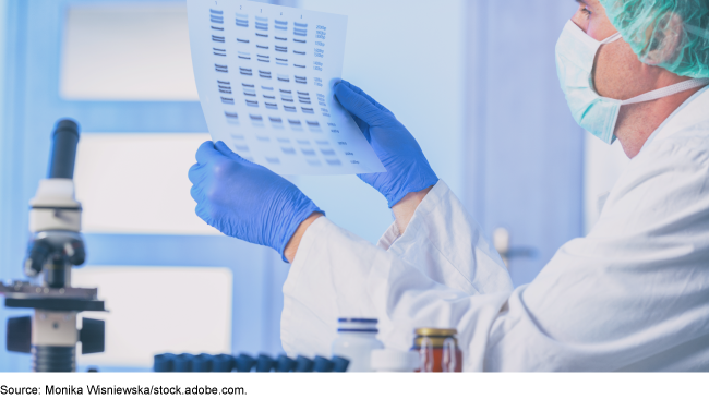 A medical technician looking at lab results.