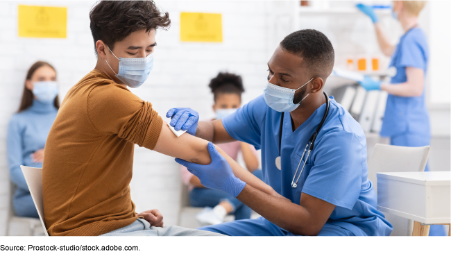 Medical professional preparing to administer a vaccine. 