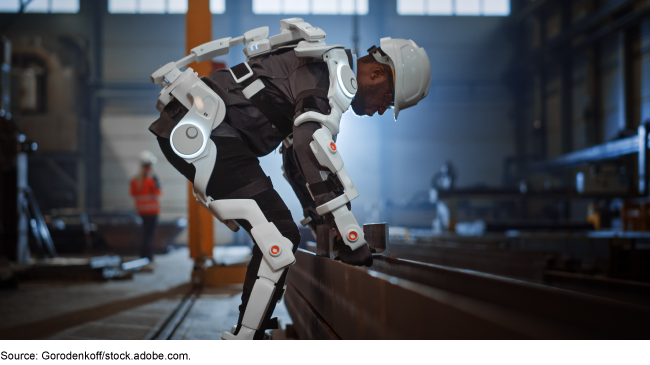 person working inside a warehouse wearing an exoskeleton and hardhat 