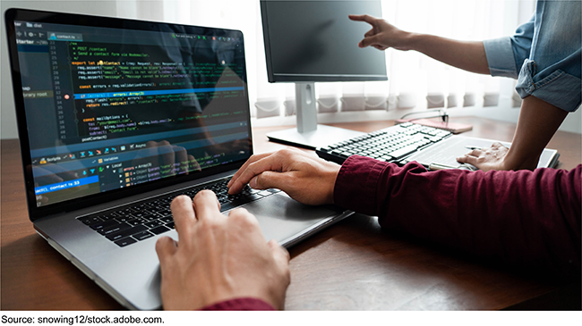 image of person using computer with programming software