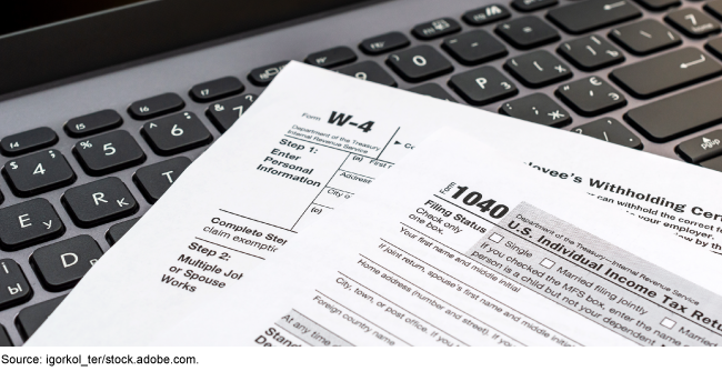 Tax forms resting on a keyboard