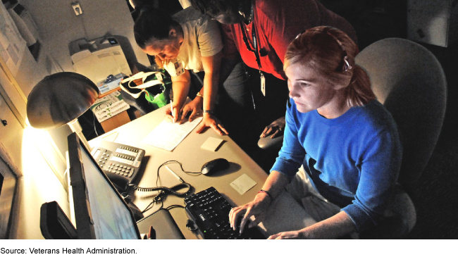 Three individuals working and taking calls in an emergency call center.