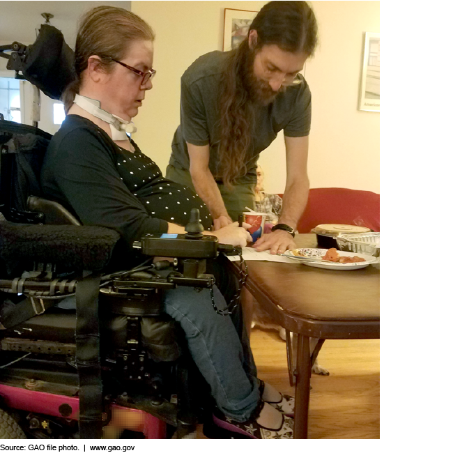 Woman in a complex wheelchair and her caregiver