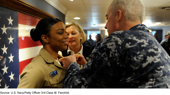 U.S. Navy officer being awarded an insignia