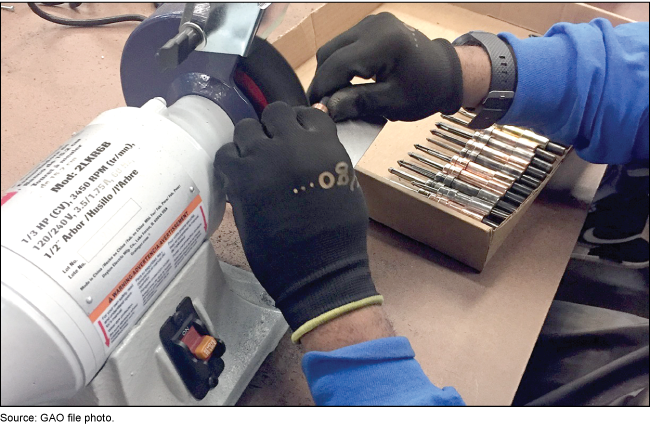 Worker using a grinder to make something