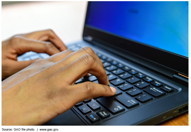 Photo Showing Someone Typing on a Laptop