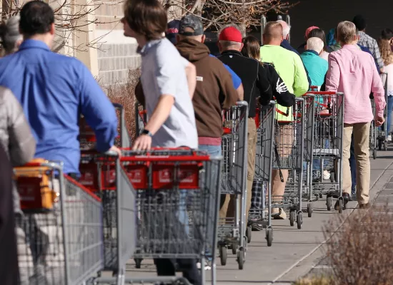 people waiting in line to buy groceries. Source: Pond5.