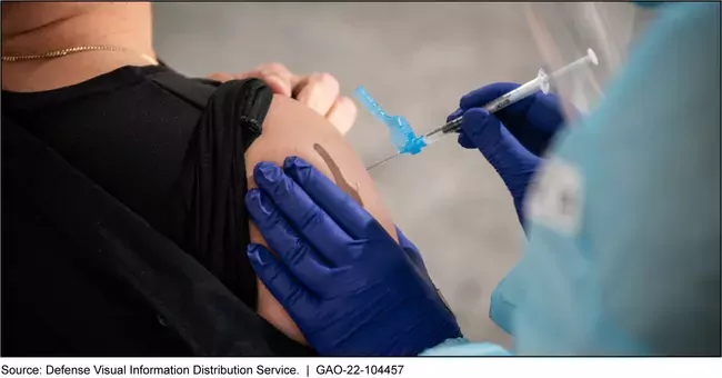 Photo showing a woman receiving a vaccination in her upper arm
