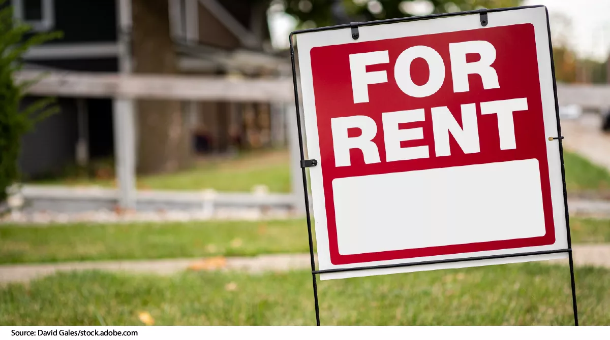 Stock image showing a "For Rent" sign in a lawn.