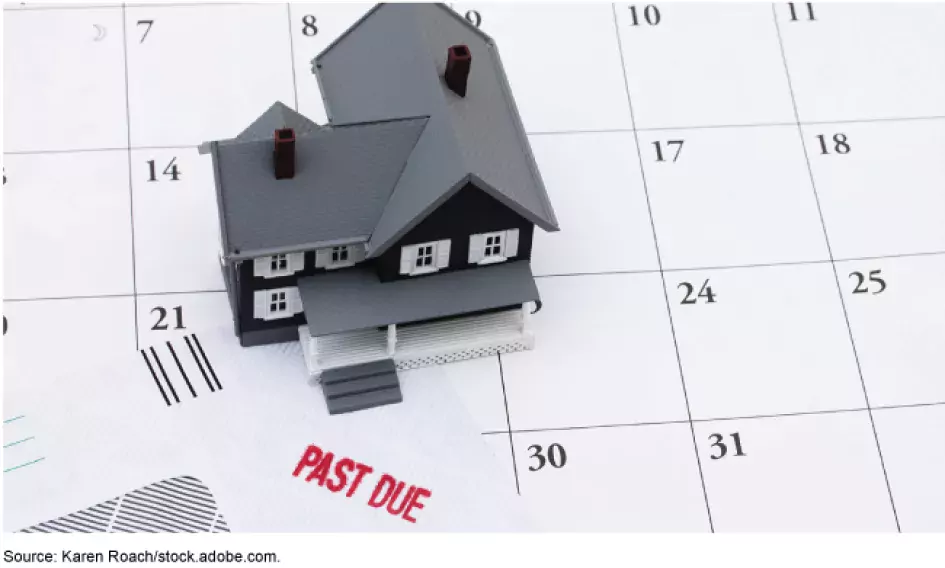 Illustration of a toy house on top of a calendar showing an overdue bill