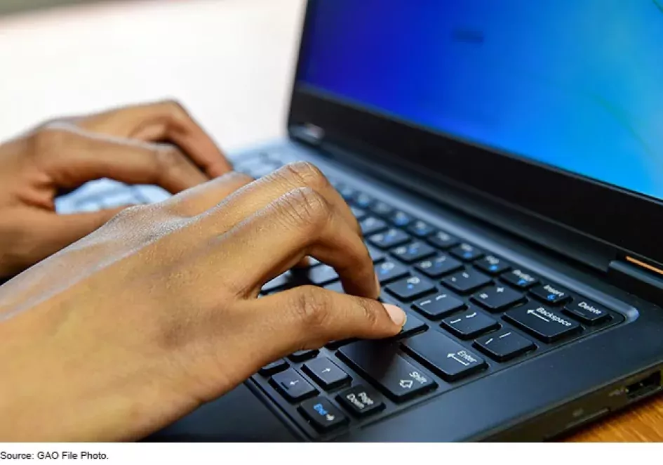 Image of Hands on a laptop keyboard